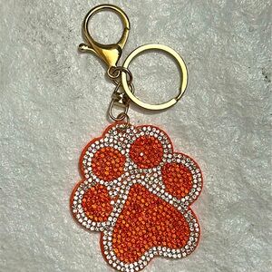 Orange and clear bling paw print 🐾 bag charm/keychain. Brand new in pkg. 6in.
